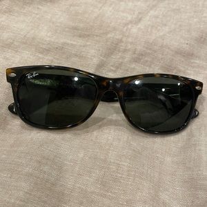Ray Ban New Wayfarer sunglasses. There is a small scratch on the left lens